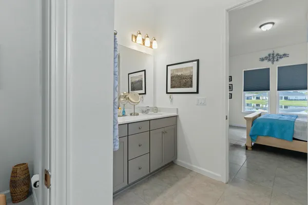 a en suite bathroom with a sink a mirror and shower