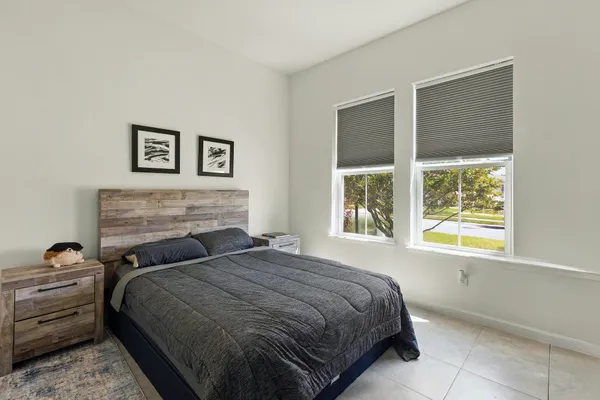 a bedroom with a bed and wall painting