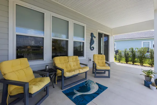 a front view of a house with a garden and lake view