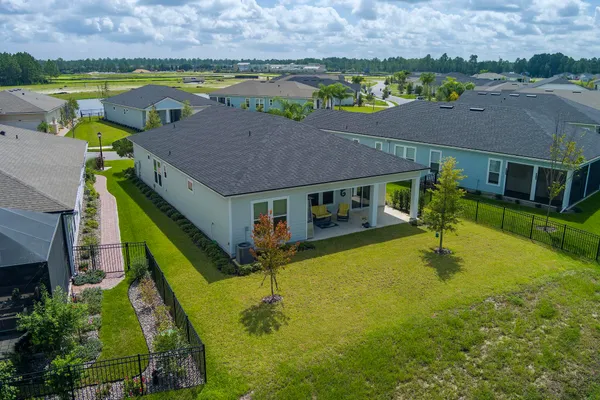 an aerial view of a house with a big yard