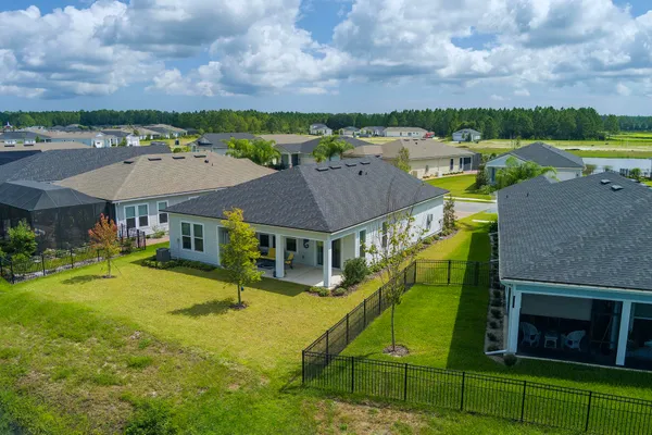 an aerial view of a house swimming pool patio outdoor seating and outdoor kitchen