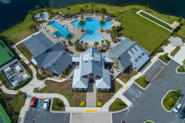 a view of a swimming pool with a yard and outdoor seating