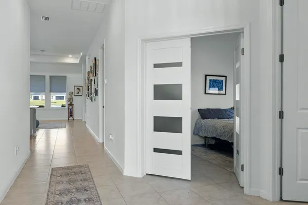 a view of a bedroom with a bed and a view of bathroom