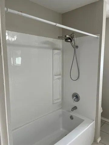 a view of room with window and wooden floor