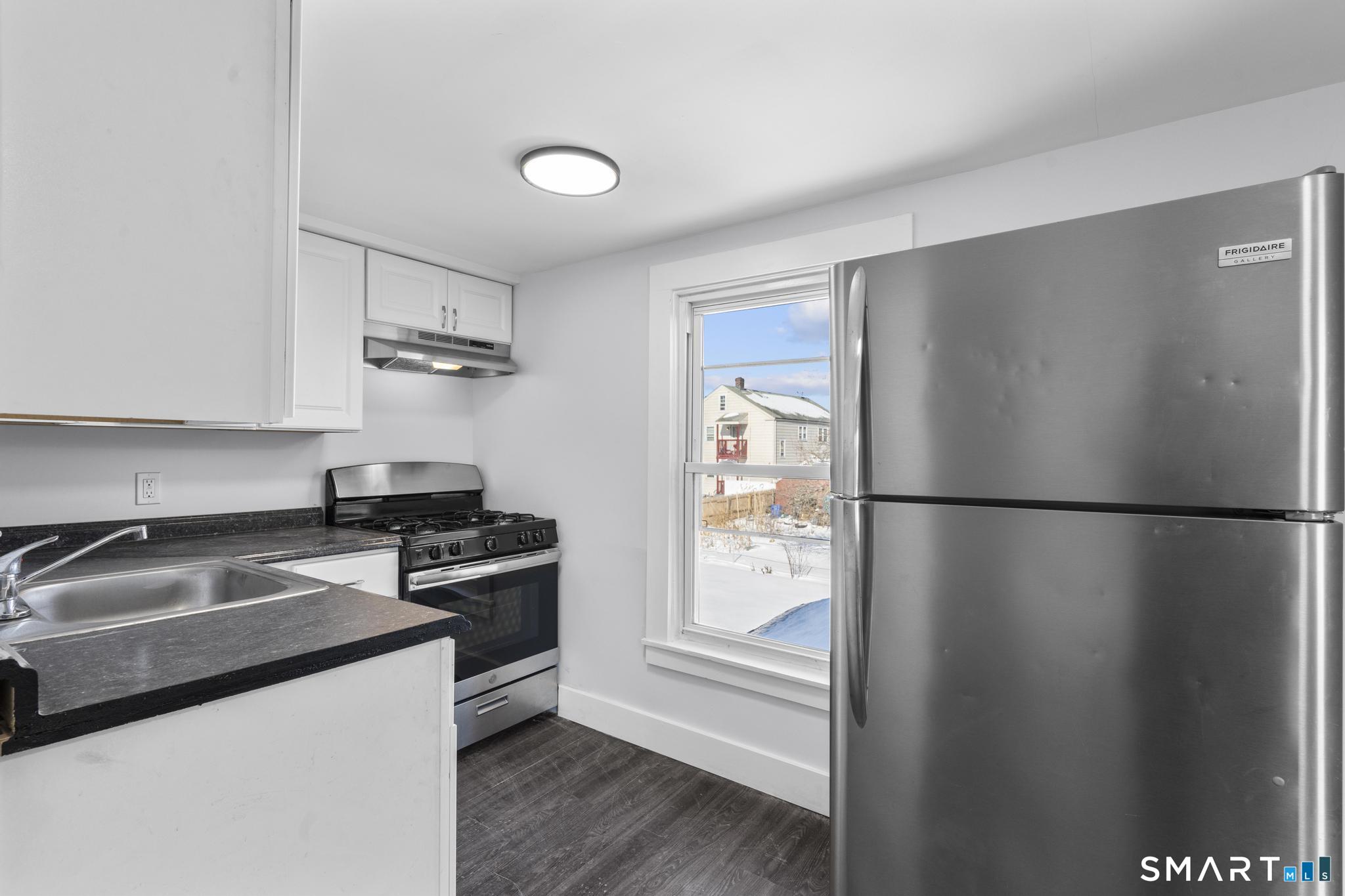 59 Pine Street Hamden, CT 06514 - Photo 20 of 36 a kitchen with stainless steel appliances a refrigerator a stove a sink and a microwave