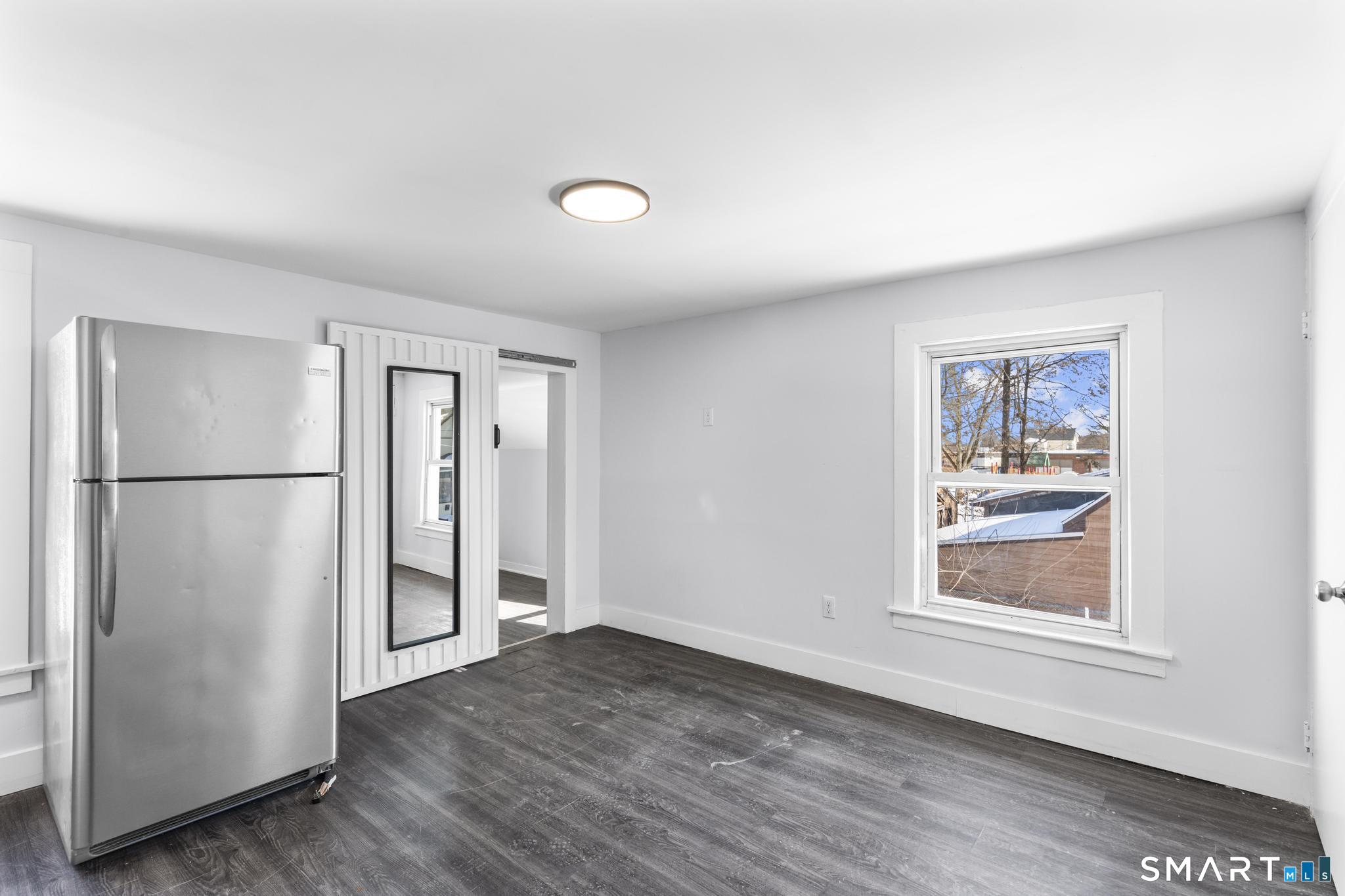59 Pine Street Hamden, CT 06514 - Photo 22 of 36 a view of an empty room with wooden floor and a window