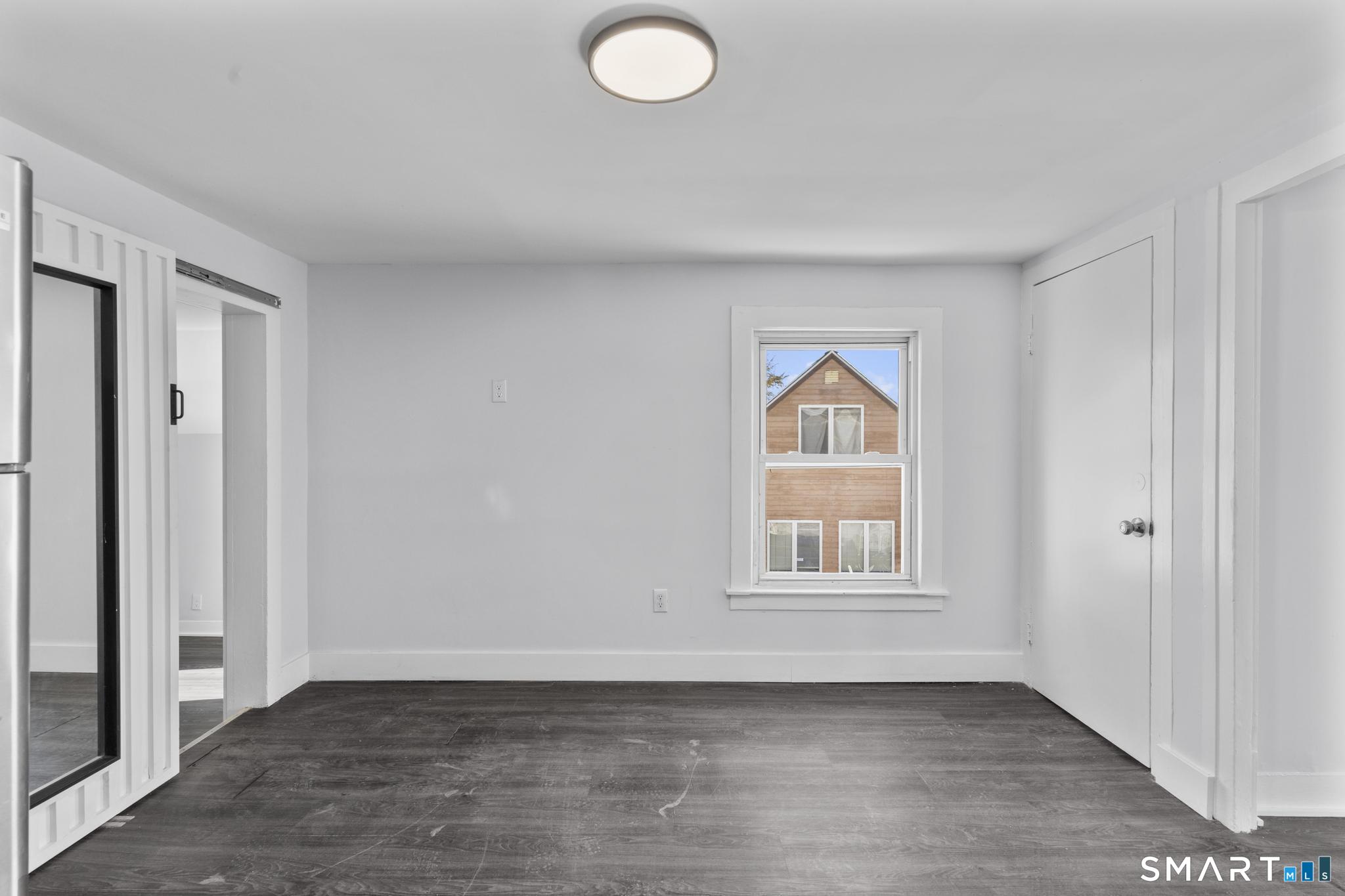 59 Pine Street Hamden, CT 06514 - Photo 23 of 36 an empty room with wooden floor and windows
