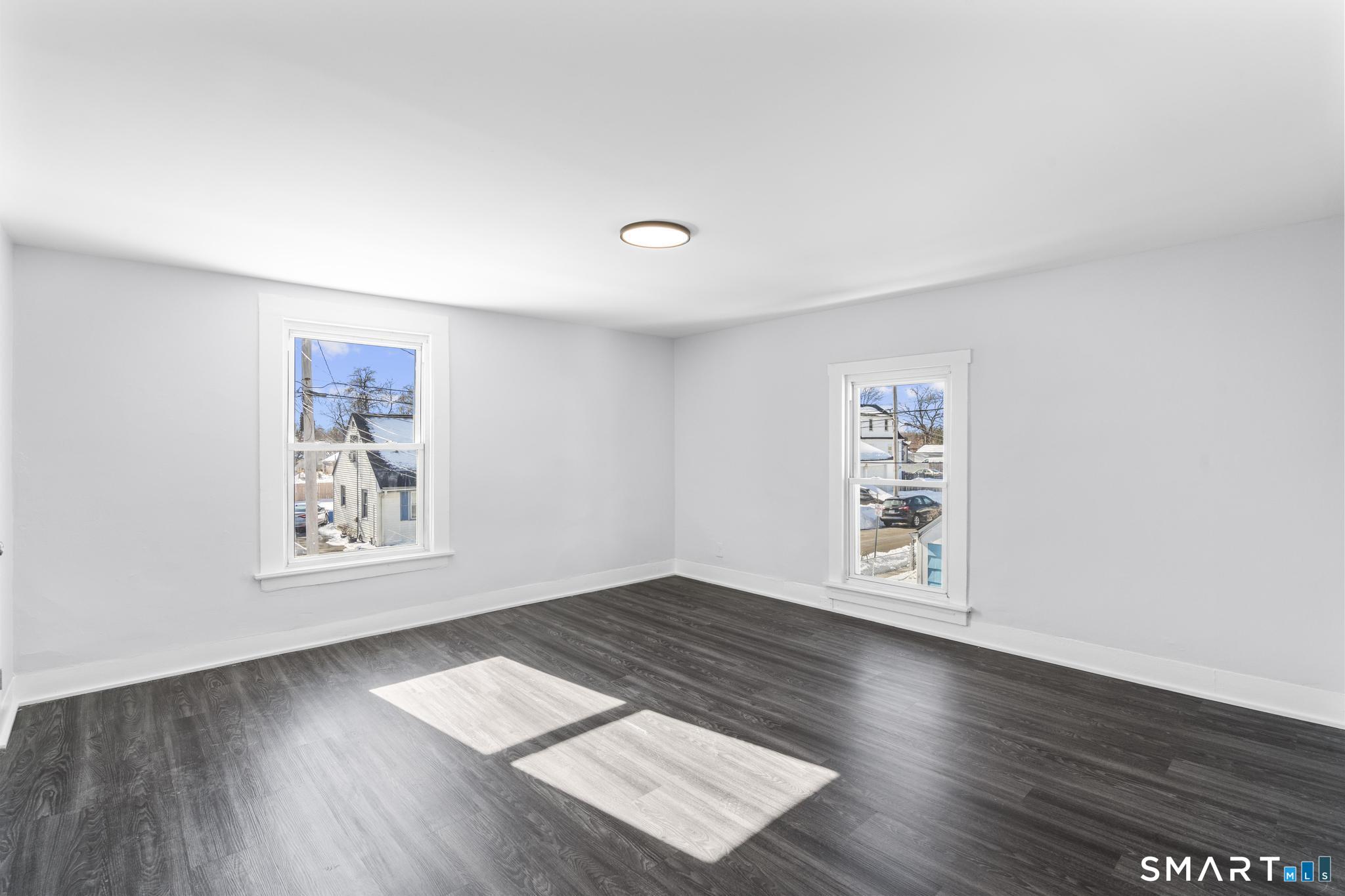 59 Pine Street Hamden, CT 06514 - Photo 24 of 36 an empty room with wooden floor and windows