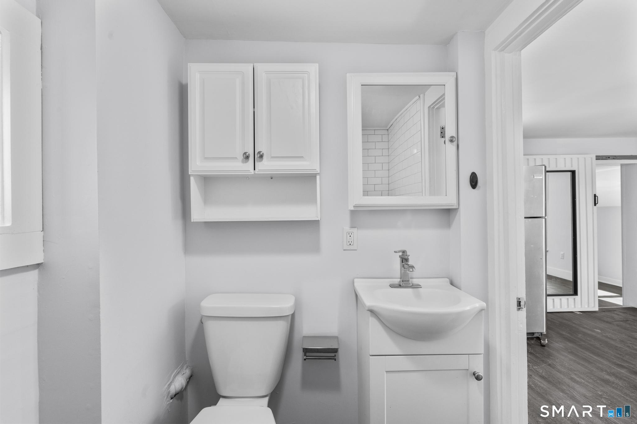 59 Pine Street Hamden, CT 06514 - Photo 28 of 36 a bathroom with a toilet sink and mirror