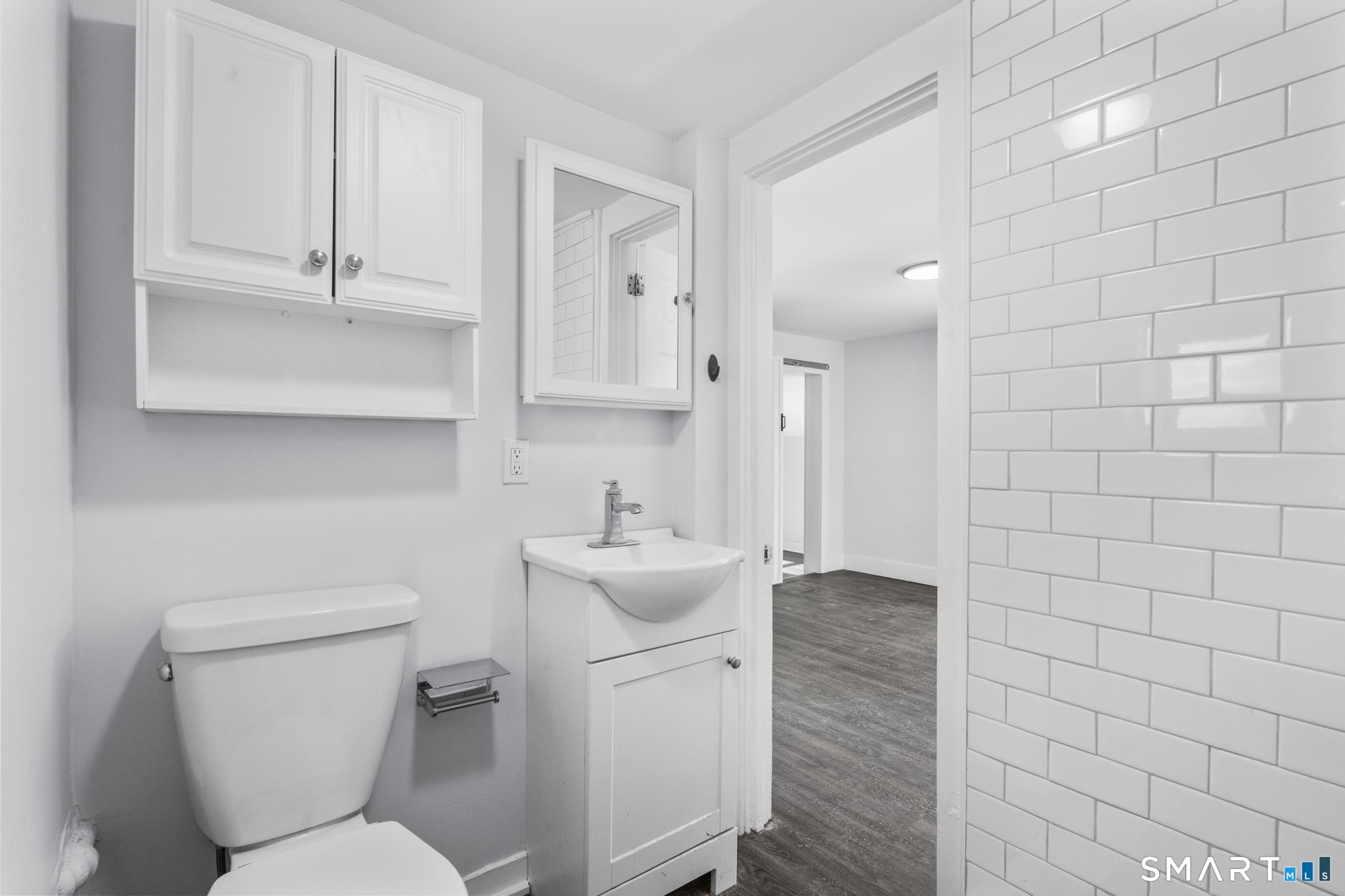 59 Pine Street Hamden, CT 06514 - Photo 29 of 36 a bathroom with a toilet sink and mirror