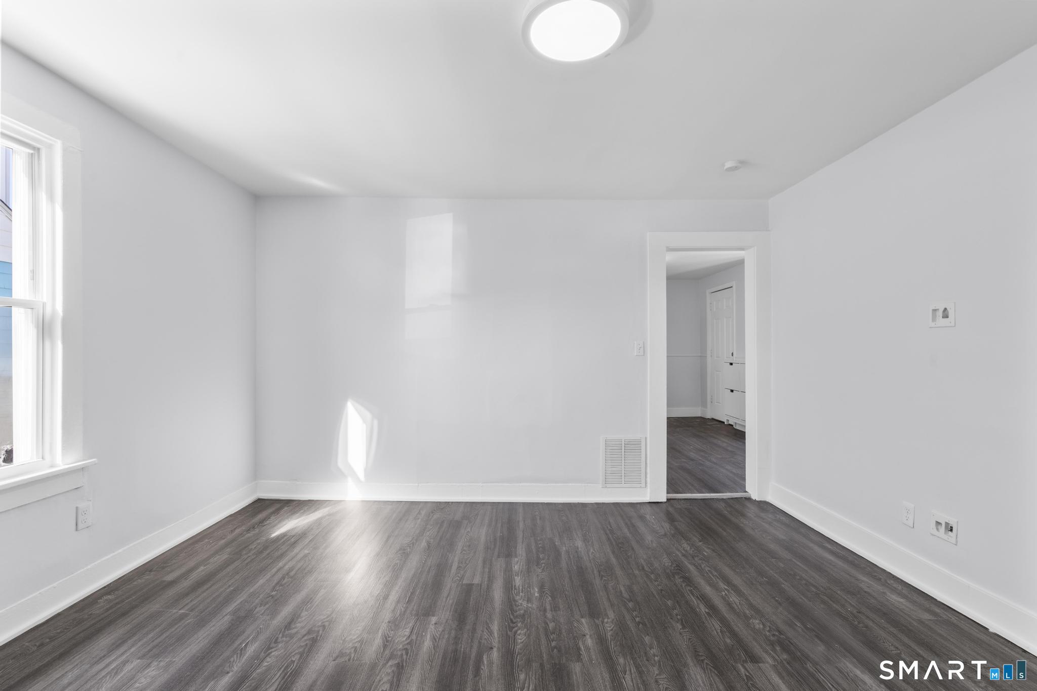 59 Pine Street Hamden, CT 06514 - Photo 3 of 36 a view of empty room with wooden floor and fan