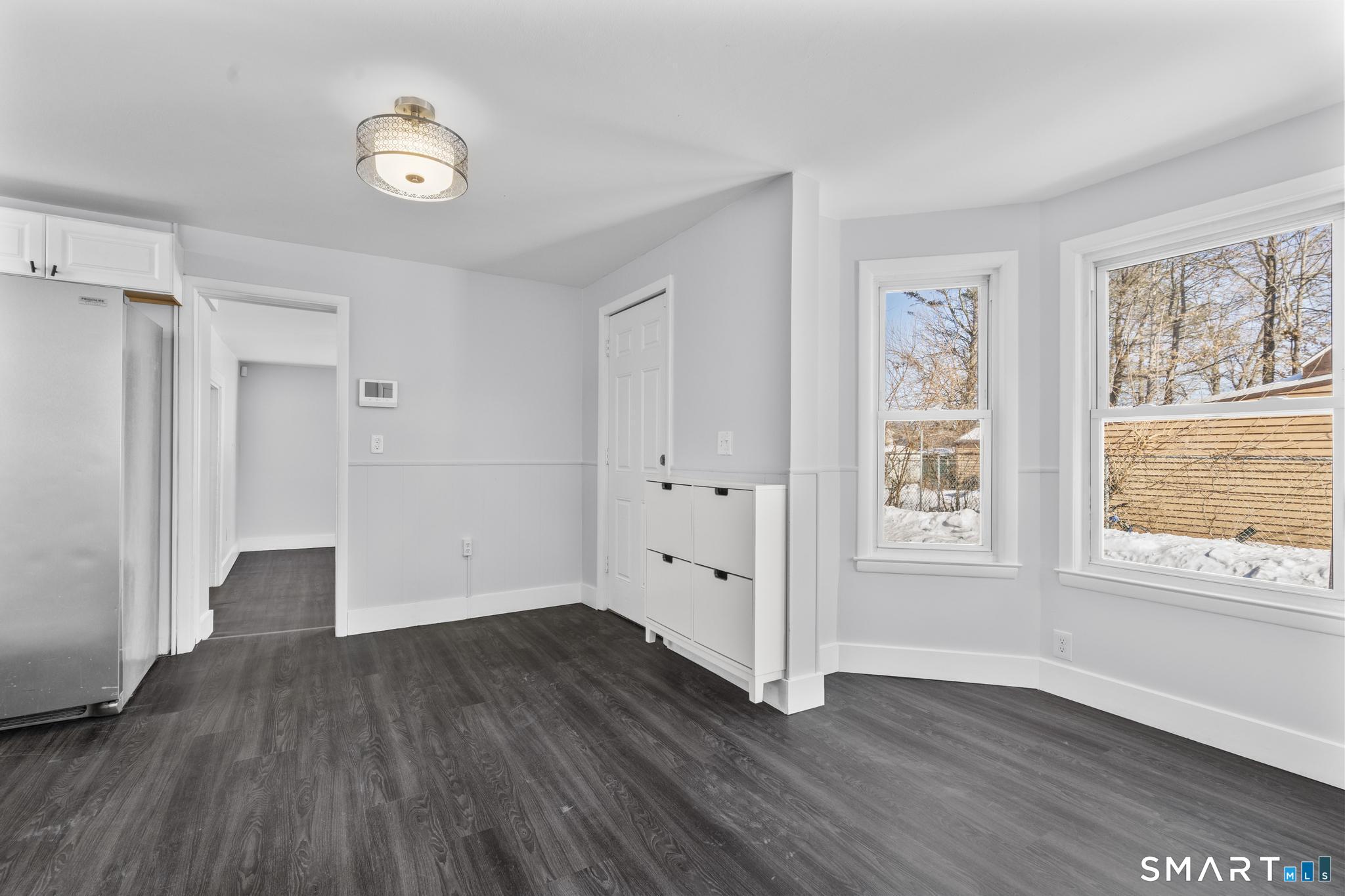 59 Pine Street Hamden, CT 06514 - Photo 4 of 36 an empty room with wooden floor and windows