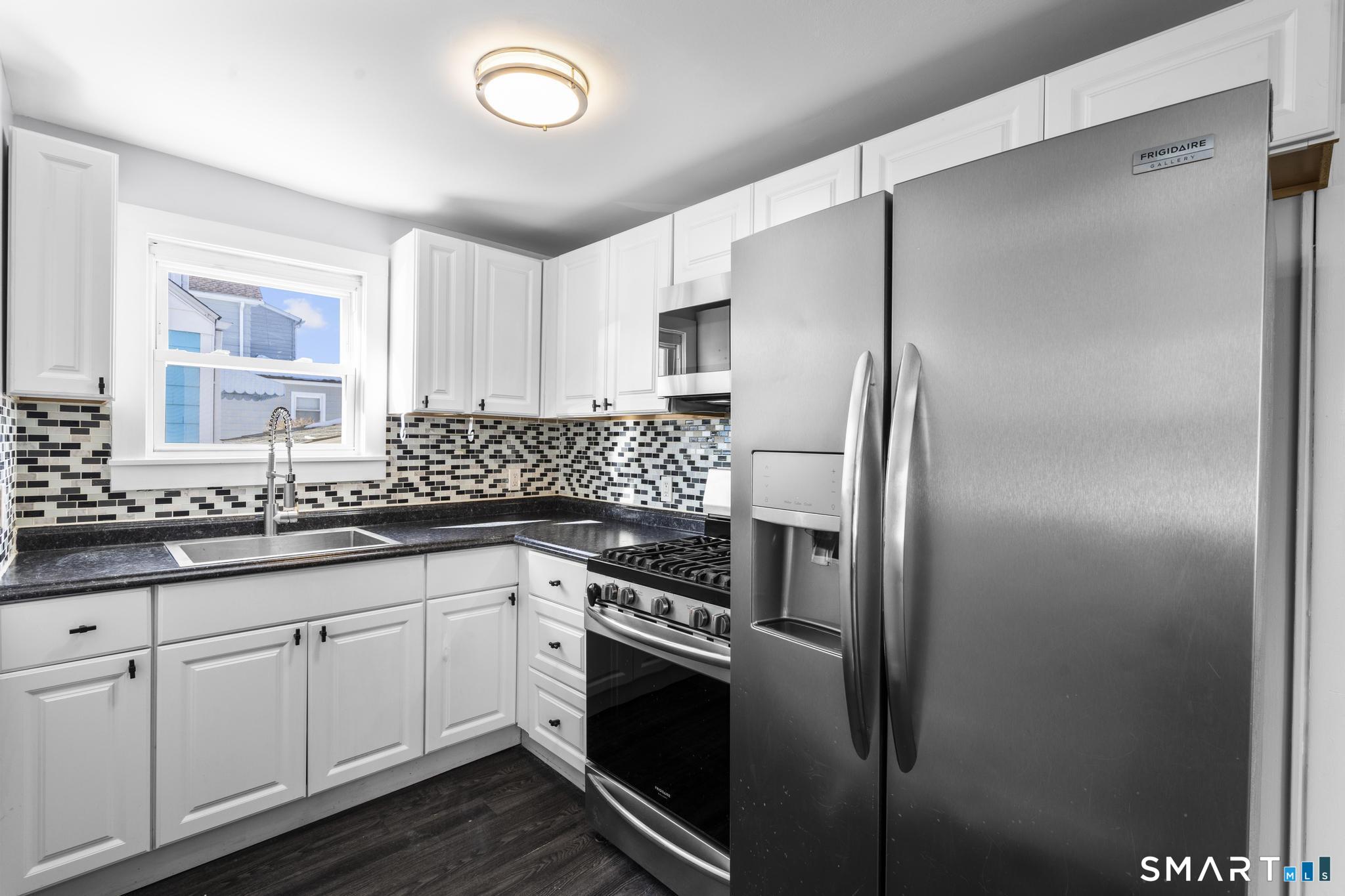 59 Pine Street Hamden, CT 06514 - Photo 5 of 36 a kitchen with stainless steel appliances granite countertop a refrigerator and a sink