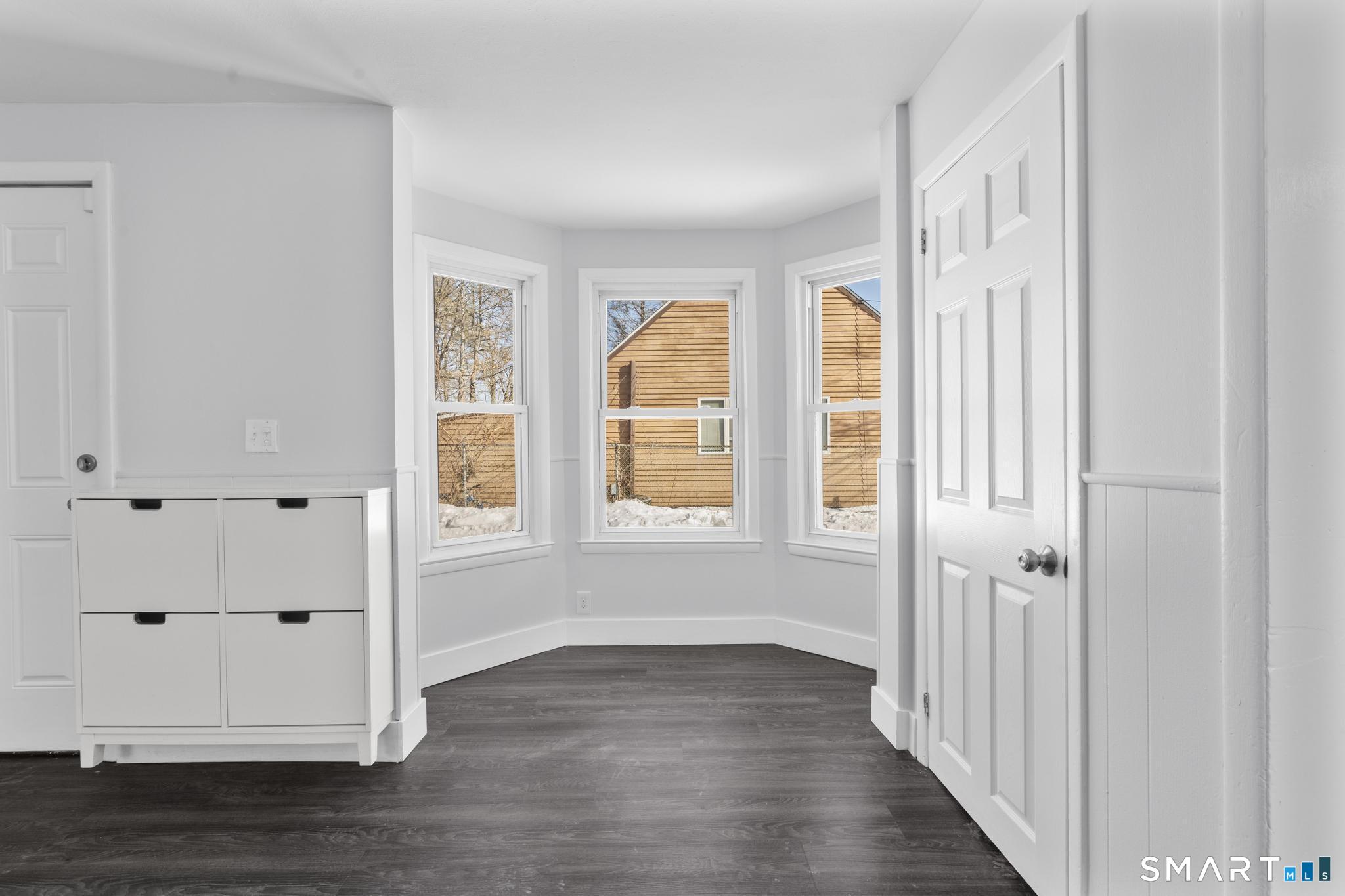 59 Pine Street Hamden, CT 06514 - Photo 7 of 36 an empty room with wooden floor and windows