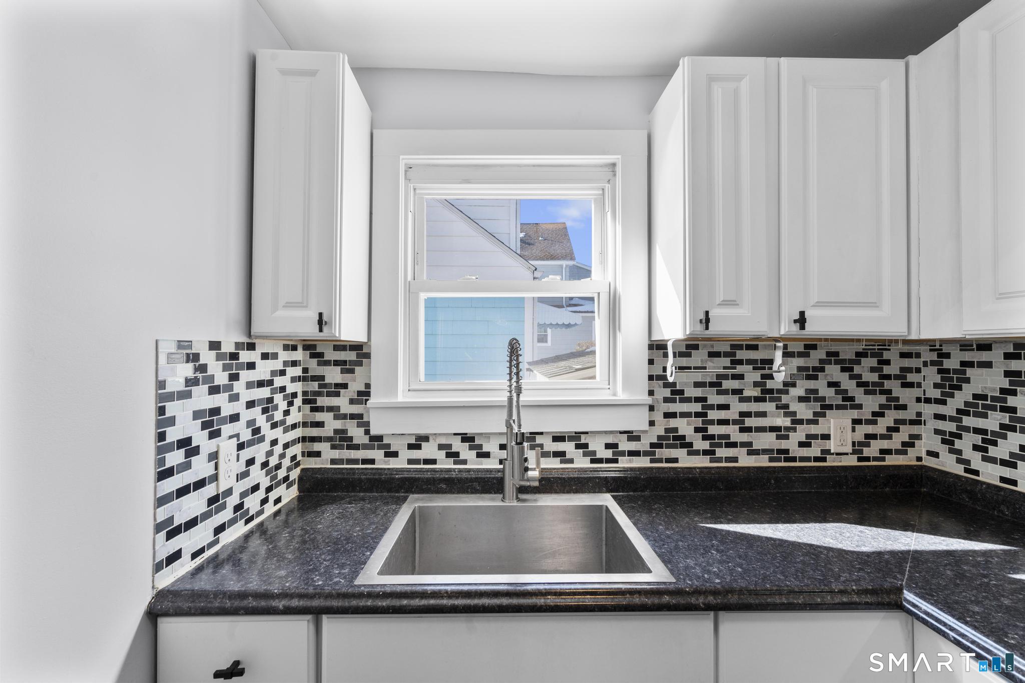 59 Pine Street Hamden, CT 06514 - Photo 9 of 36 a kitchen with a sink and cabinets