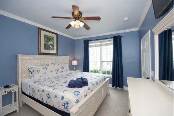 a bedroom with a large bed and a window