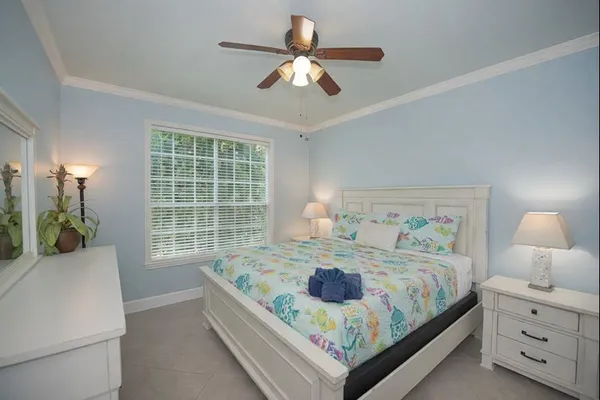 a bedroom with a bed and a large window