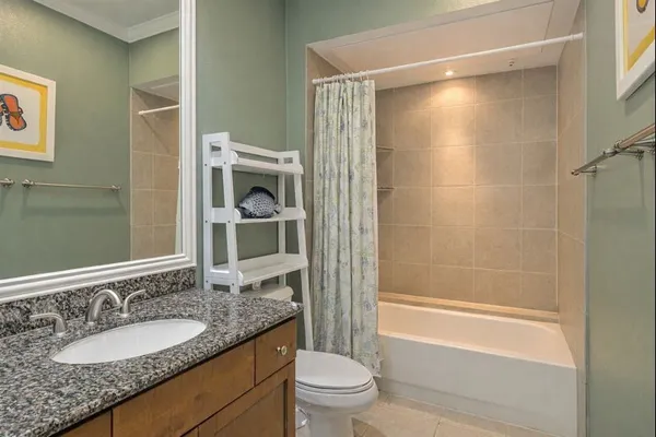 a bathroom with a granite countertop sink toilet and shower