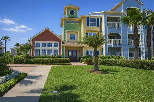 a front view of a house with yard and green space