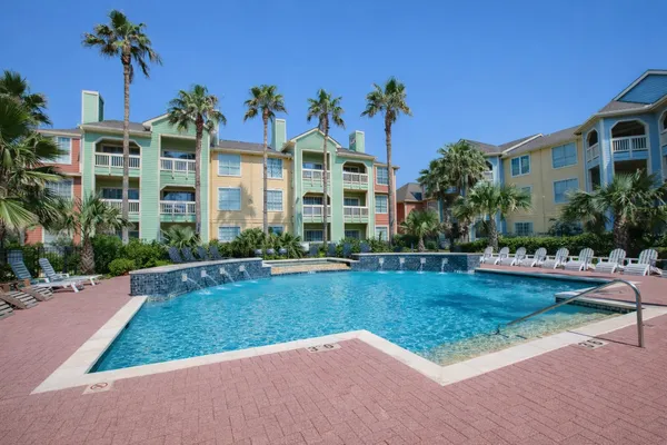 a view of a house with swimming pool and sitting area