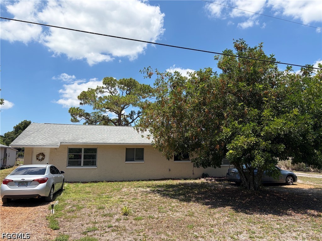 2175 Twin Brooks Road North Fort Myers, FL 33917 - Photo 2 of 27 a front view of a house with a yard and garage