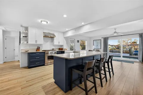 a kitchen with stainless steel appliances granite countertop a stove and a sink