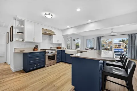 a kitchen with a stove a sink and cabinets