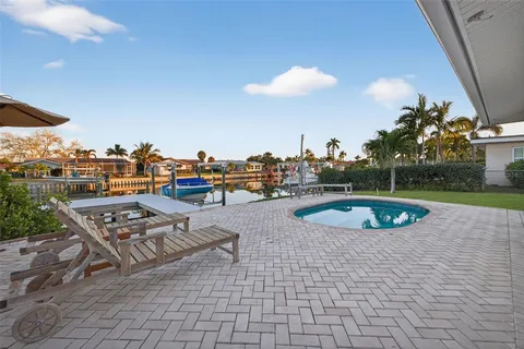 a swimming pool with outdoor seating yard and barbeque oven