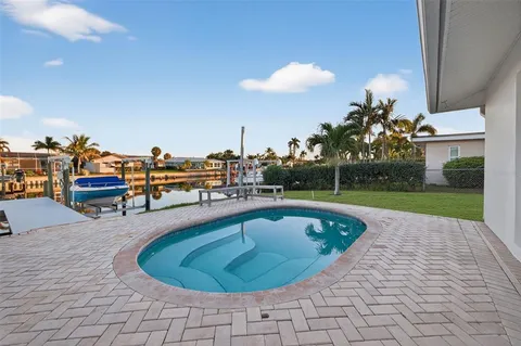 a view of a swimming pool with outdoor seating
