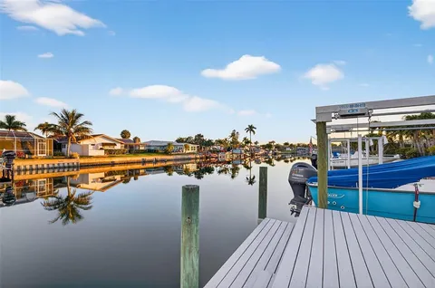 a lawn chairs sitting in the middle of a lake