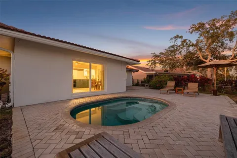 a view of a swimming pool with sitting area