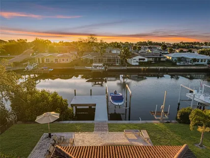 a view of a lake with couches in patio