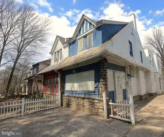 a view of a house with wooden fence
