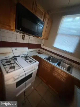 a view of a room with window and stainless steel appliances