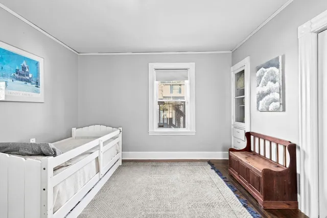 a bedroom with furniture and baby crib