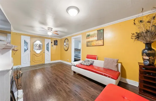 a living room with furniture and painting on the wall