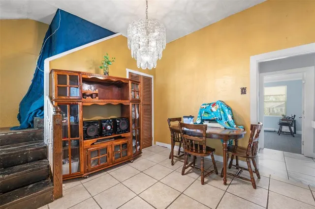 a view of a dining room with furniture and chandelier