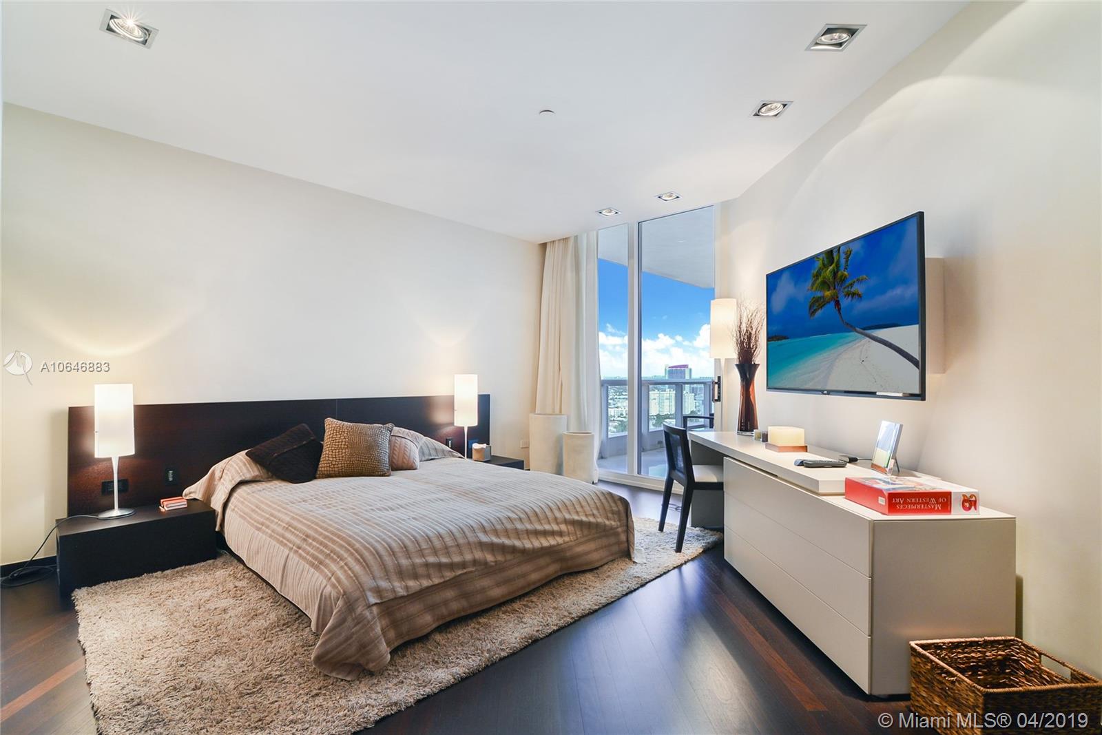 21200 Point Place Aventura, FL 33180 - Photo 26 of 35 GUEST BEDROOM WITH WOOD FLOORS, WALKING CLOSET AND BATHROOM - BALCONY ACCESS