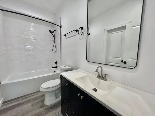 a bathroom with a sink toilet tub and shower