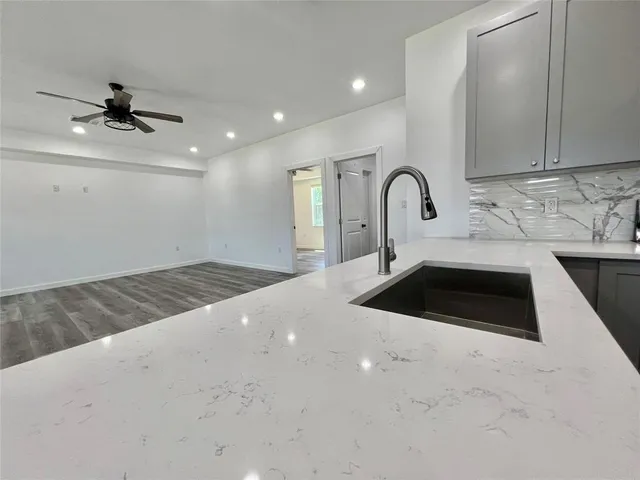 a view of empty room with ceiling fan