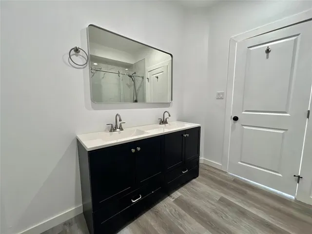 a kitchen with a sink a refrigerator and cabinets