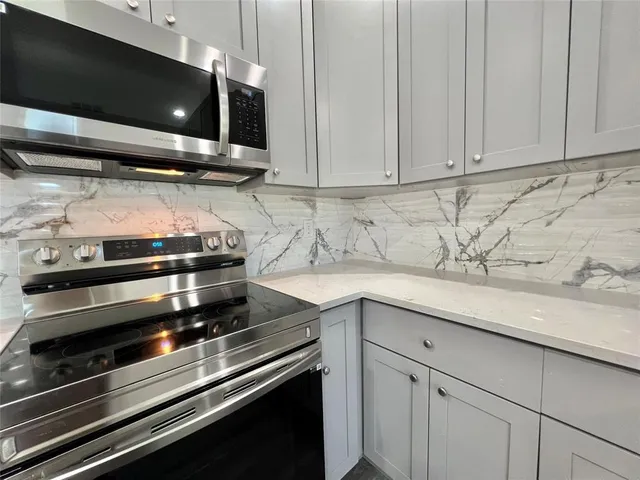 a kitchen with a stove and a microwave