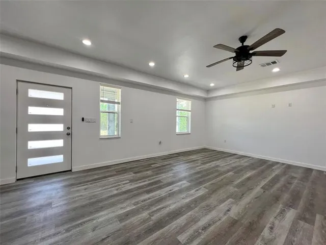 wooden floor in an empty room with a window
