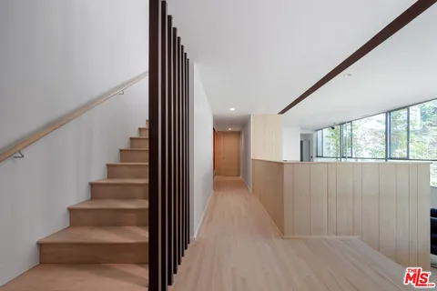 a view of an entryway with wooden floor