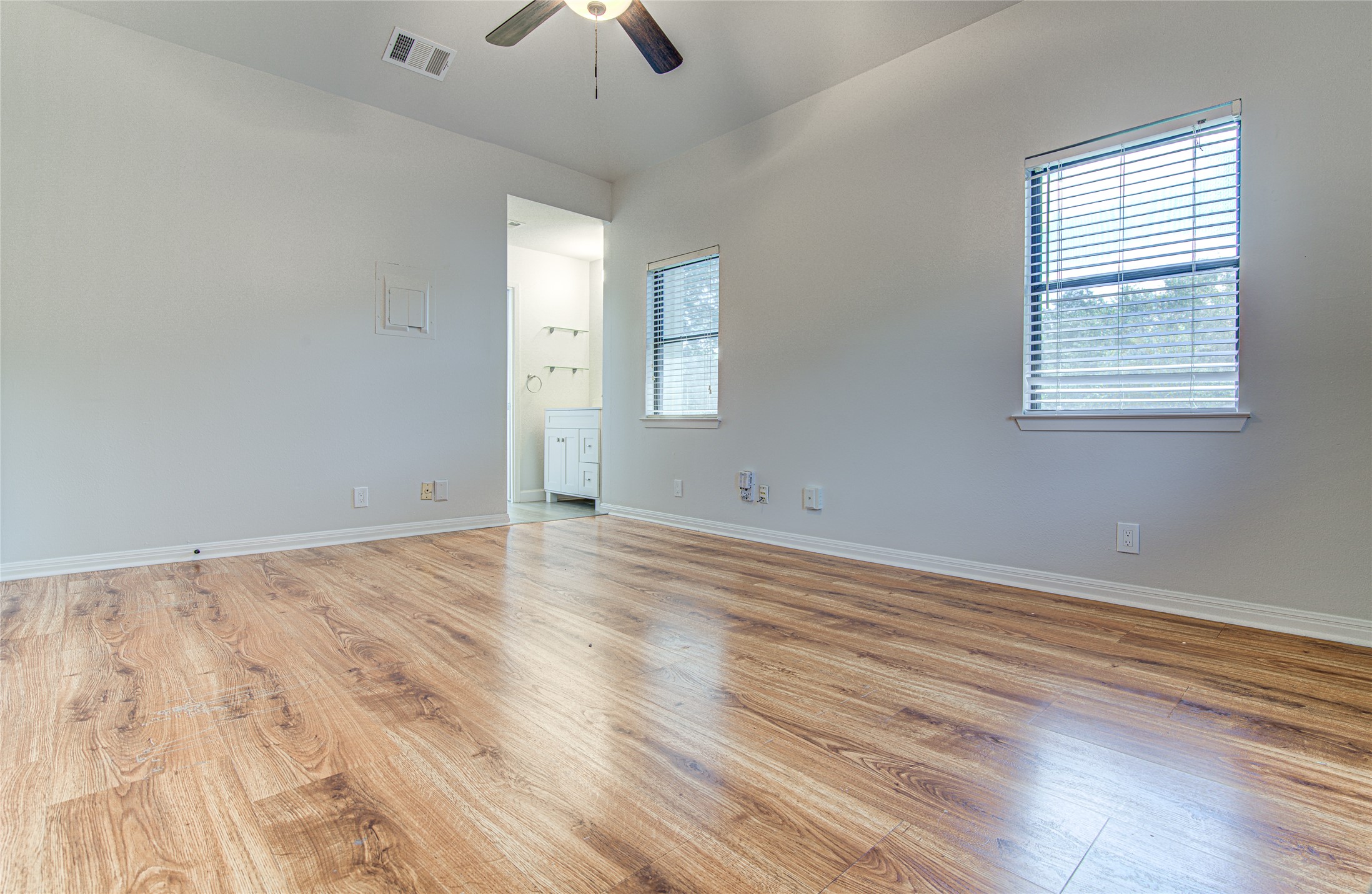 311 West Mary Street Austin, TX 78704 - Photo 9 of 35 Vast wooden flooring creates an inviting atmosphere in this versatile bedroom space.
