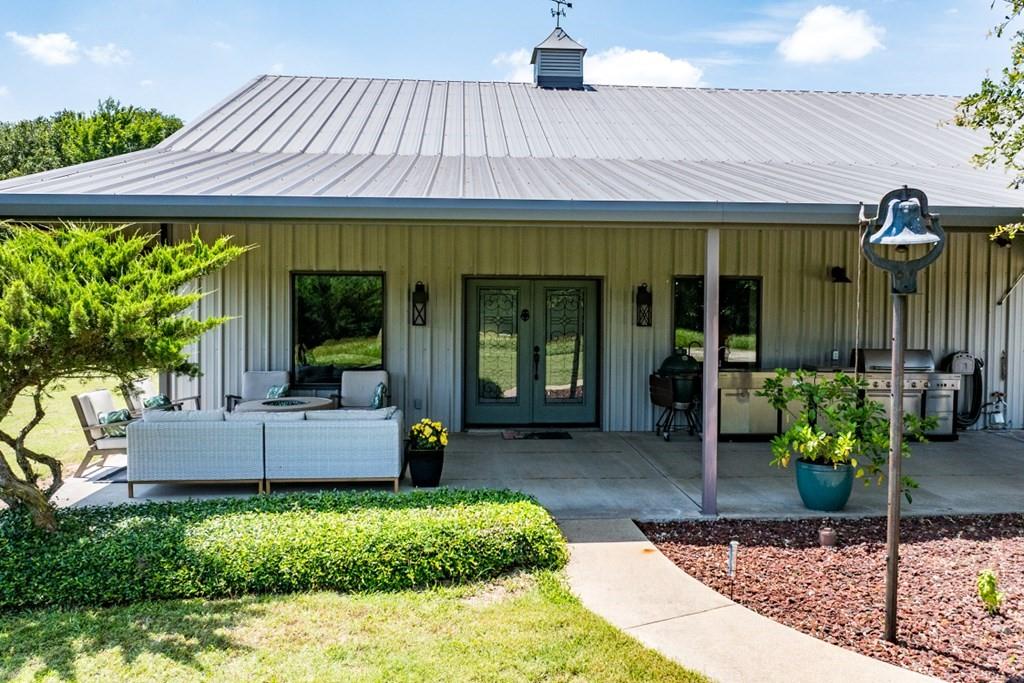 455 County Road 2808 Mabank, TX 75147 - Photo 5 of 40 a view of a patio with a table and chairs under an umbrella