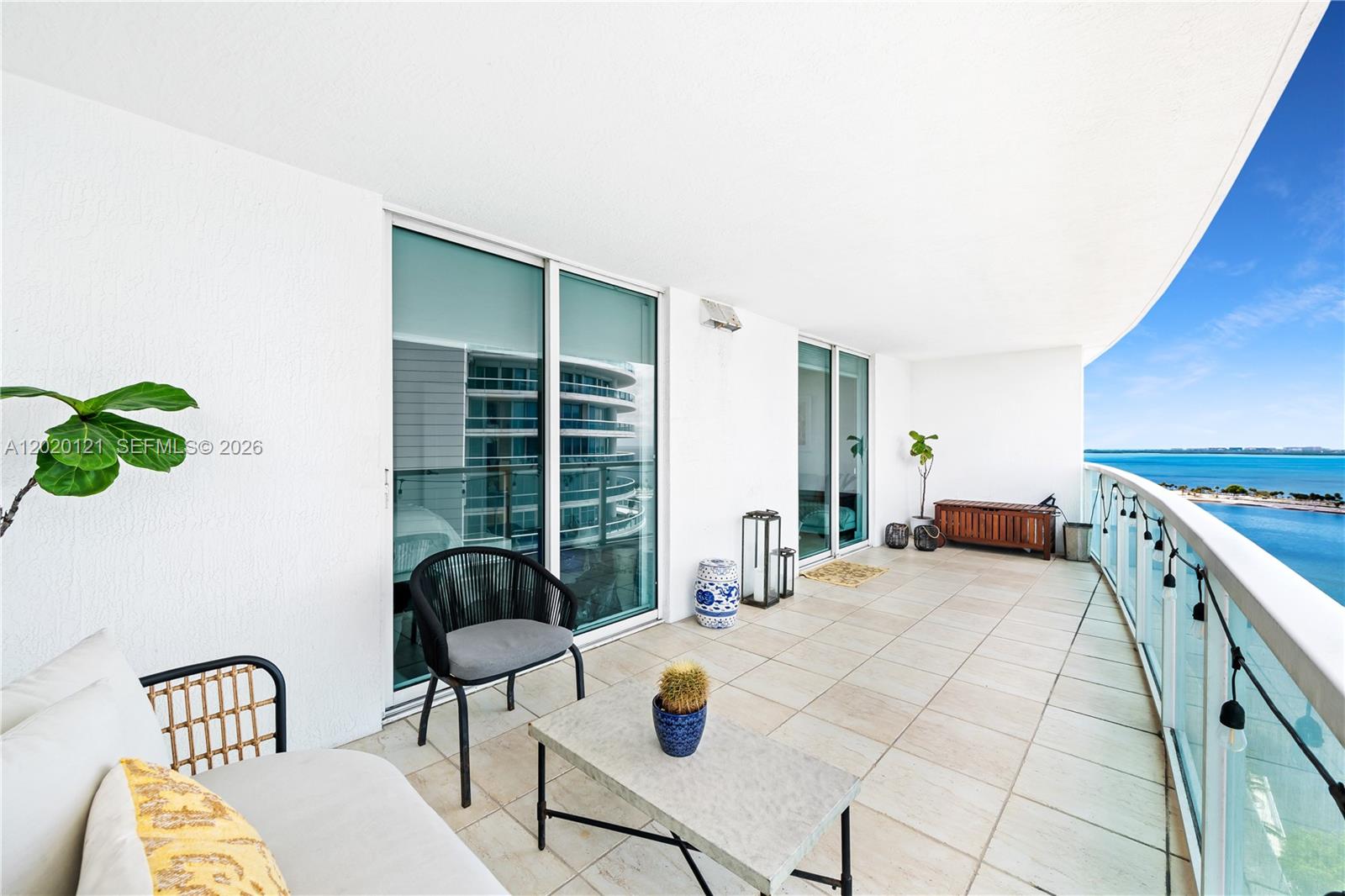2101 Brickell Avenue, Unit 1909 Miami, FL 33129 - Photo 18 of 25 a bedroom with a bed and a chair