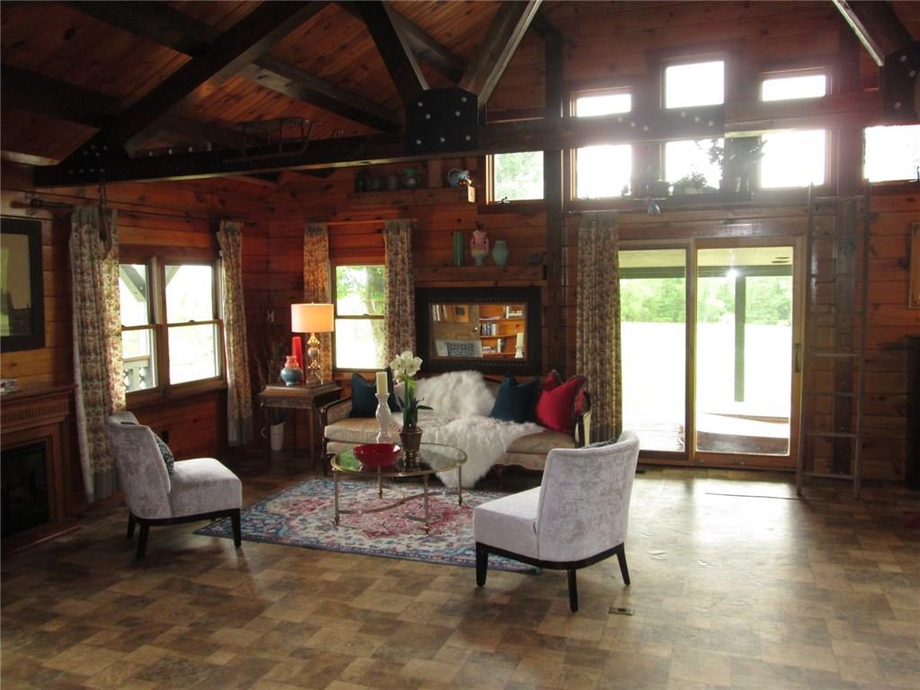 294 Iron Bridge Road Kittanning, PA 16201 - Photo 15 of 24 A view of the full wall of windows, living room , looking out through the sliding doors to the covered porch and fields.