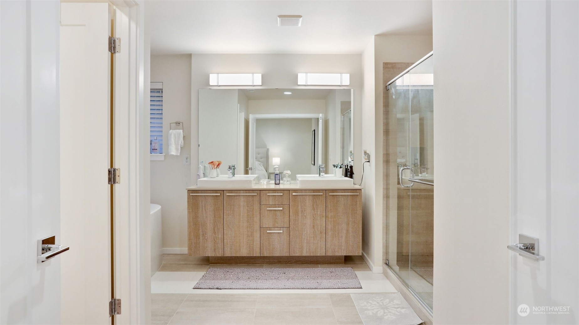 23922 Southeast 258th Way Maple Valley, WA 98038 - Photo 16 of 30 a bathroom with a sink a mirror and a shower
