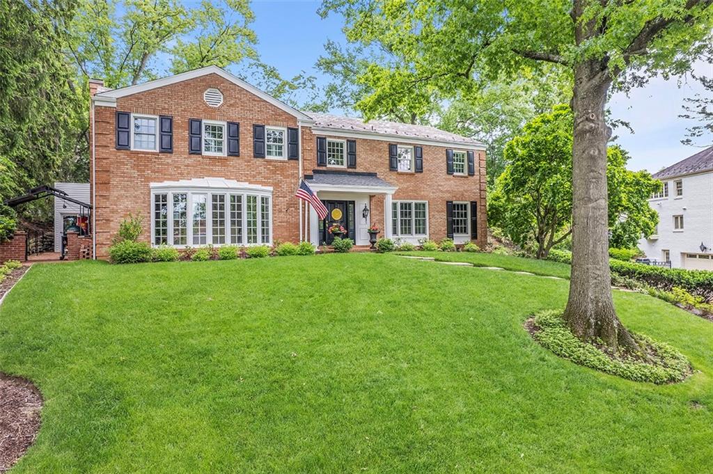 a front view of a house with a garden
